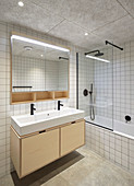 White wall tiles and concrete floor in bathroom