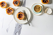 Puff pastry tarts filled with pudding, served with coffee