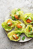 Salmon meatballs with avocado cream in lettuce leaves