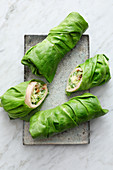Caesar salad wraps with sliced chicken and lettuce leaves
