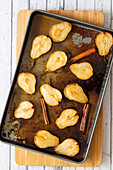 Maple and cinnamon roasted pears on a baking tray