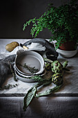 Different herbs in bowls placed on rustic table