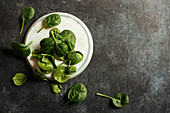 Fresh spinach on a rustic concrete crockery