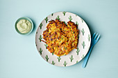 A vegetable fritter with green sauce (from 11 months)