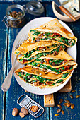 Crepes with spinach, dried tomatoes and blue cheese