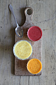 Different coloured carrot soups