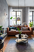 Brown leather sofa in masculine living room in muted shades