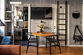 Two chairs at round table in grey, masculine living room