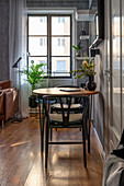 Two chairs at round table in grey, masculine living room