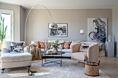Various upholstered furnishings in elegant, beige living room