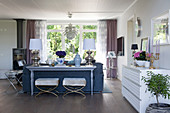 Console table against back of sofa in classic, open-plan interior