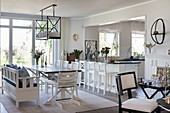 Dining table next to open doorway leading into kitchen in open-plan interior