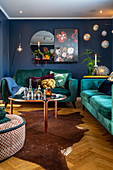 Teal sofa set in interior with blue walls