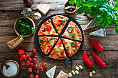 Pizza with cheese, tomatoes and basil