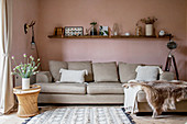 Chaise couch in living room with pastel-pink walls