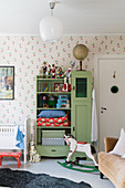 Old green cupboard in vintage-style child's bedroom