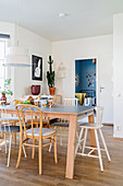 Various chairs around wooden table in Scandinavian-style dining room