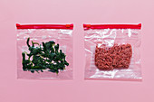 Minced meat and spinach leaves being frozen