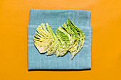 Savoy cabbage leaves spread out on a tea towel