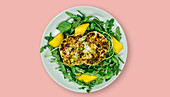 Fish cakes with mango on a bed of rocket