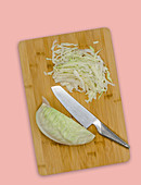 White cabbage being finely sliced
