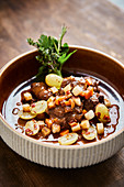 Venison ragout with grapes and bacon
