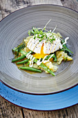 Potato salad with beans and a poached egg