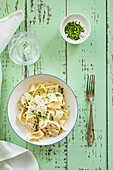 Pappardella with chicken alfredo sauce and chopped parsley