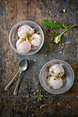 Bowls of Cardamon and Rose Ice Cream on a Rustic Board