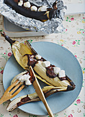 Grilled bananas with chocolate sauce and marshmallows