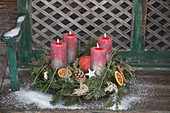 Classic Advent wreath of conifer branches, pine cones and orange slices