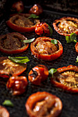 Baked raspberry tomatoes with fresh basil leaves