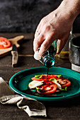 Caprese-Salat mit Balsamico-Essig beträufeln