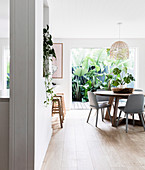 Round table and chairs in open kitchen with terrace in background