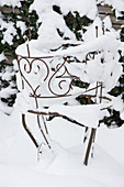 Snow-covered plant support in the wintry garden