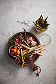 Pickled asparagus with prosciutto and grissini