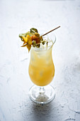A cocktail made with rum, rambutan and pineapple juice
