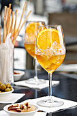 An aperitif with olives, almonds and grissini