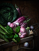 An arrangement of Savoy cabbage, garlic, basil and asparagus