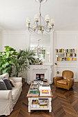 Open fireplace and herringbone parquet floor in living room of period building