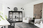 Black shelves in dining room decorated in mixture of Oriental and Scandinavian styles