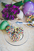 Chocolate pralines with a chocolate cream cheese cream and colourful sprinkles