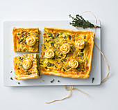 Mange tout and spring onion tart with smoked bacon and cheese flowers