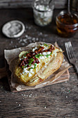 Baked potato with sun dried tomatoes and bryndza cheese