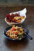 Oriental chickpea salad with dates and vegetables crisps