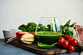 Green smoothie of apple, baby spinacj, cucumber, chia seeds on concrete background