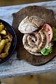 A spiral sausage burger and potato wedges