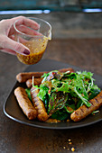 Veggie cheese sausages with a papaya and wild herb salad
