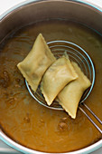 Maultaschen (Swabian ravioli) on a draining spoon