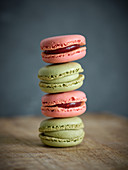 Pile of bright fresh tasty macaron biscuits on wooden table